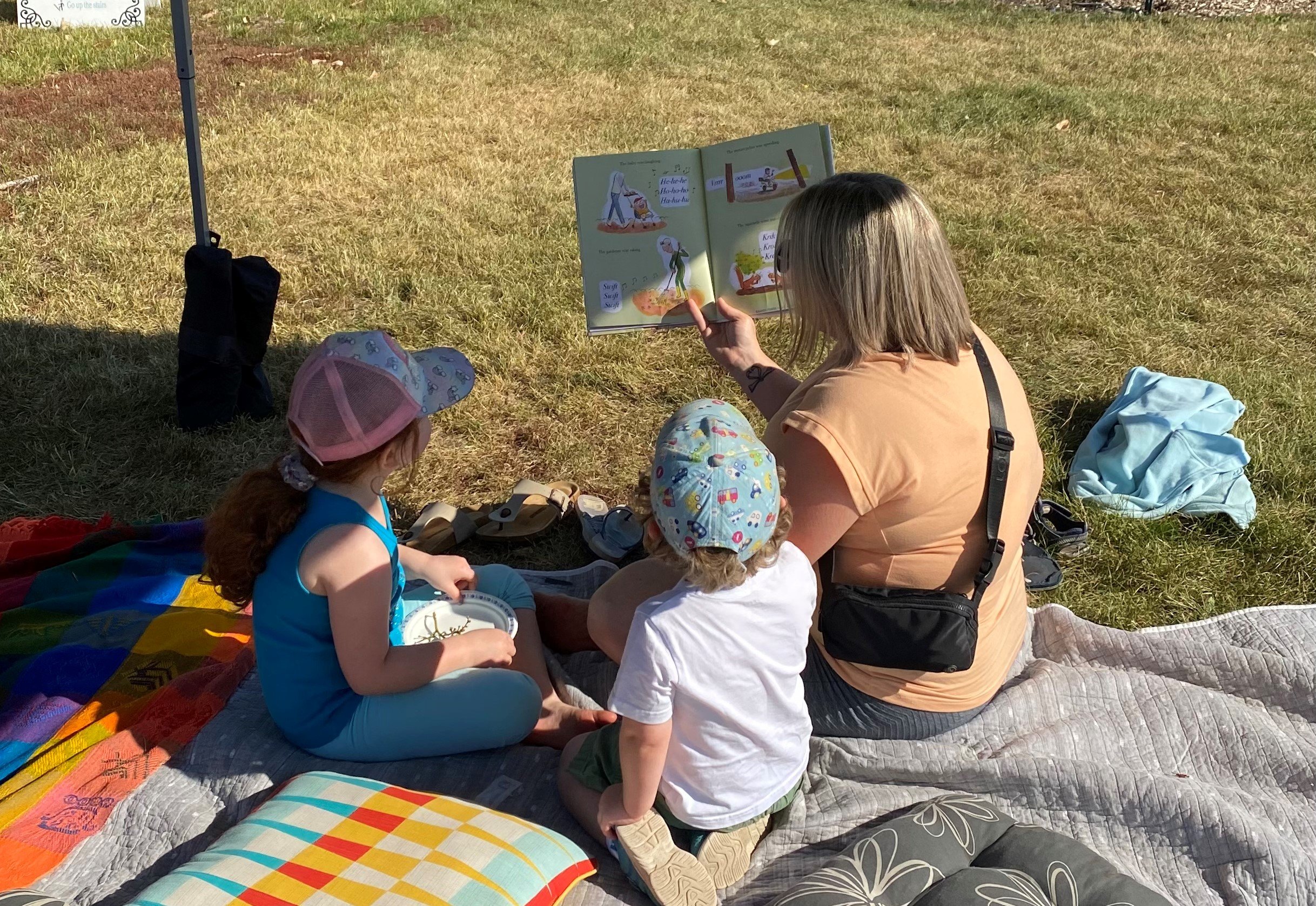 Families reading during one of a reading tent activity